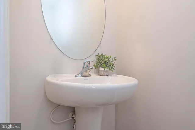 a bathroom with a sink and mirror