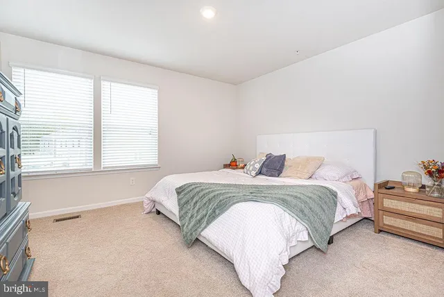 a spacious bedroom with a bed and window