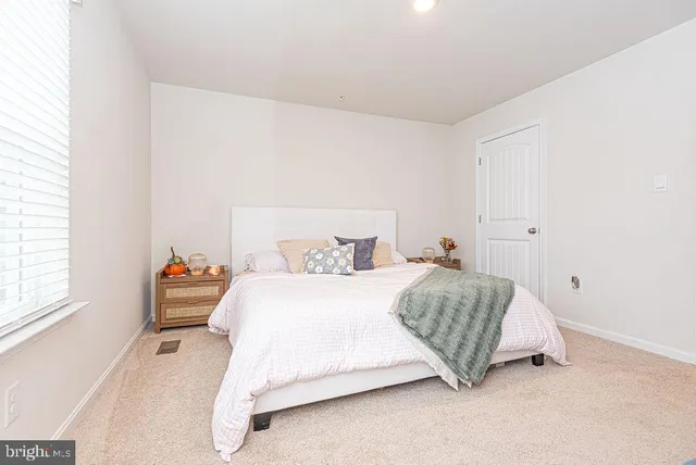 a bedroom with a bed and window