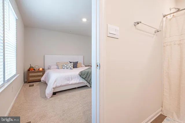 a bedroom with a bed and a window