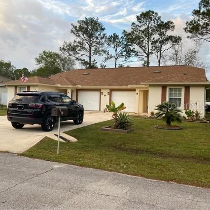 20 Whetstone Lane, Unit B Palm Coast, FL 32164 - Photo 1 of 1 a front view of a house with a garden