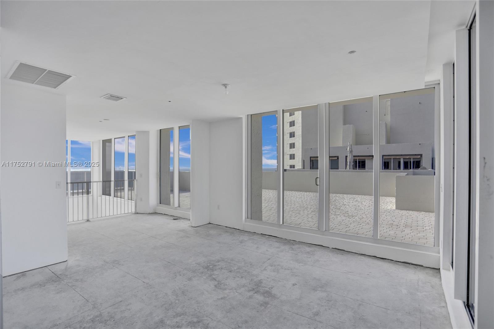 19111 Collins Avenue, Unit PH4 Sunny Isles Beach, FL 33160 - Photo 54 of 73 a view of an empty room with floor to ceiling window