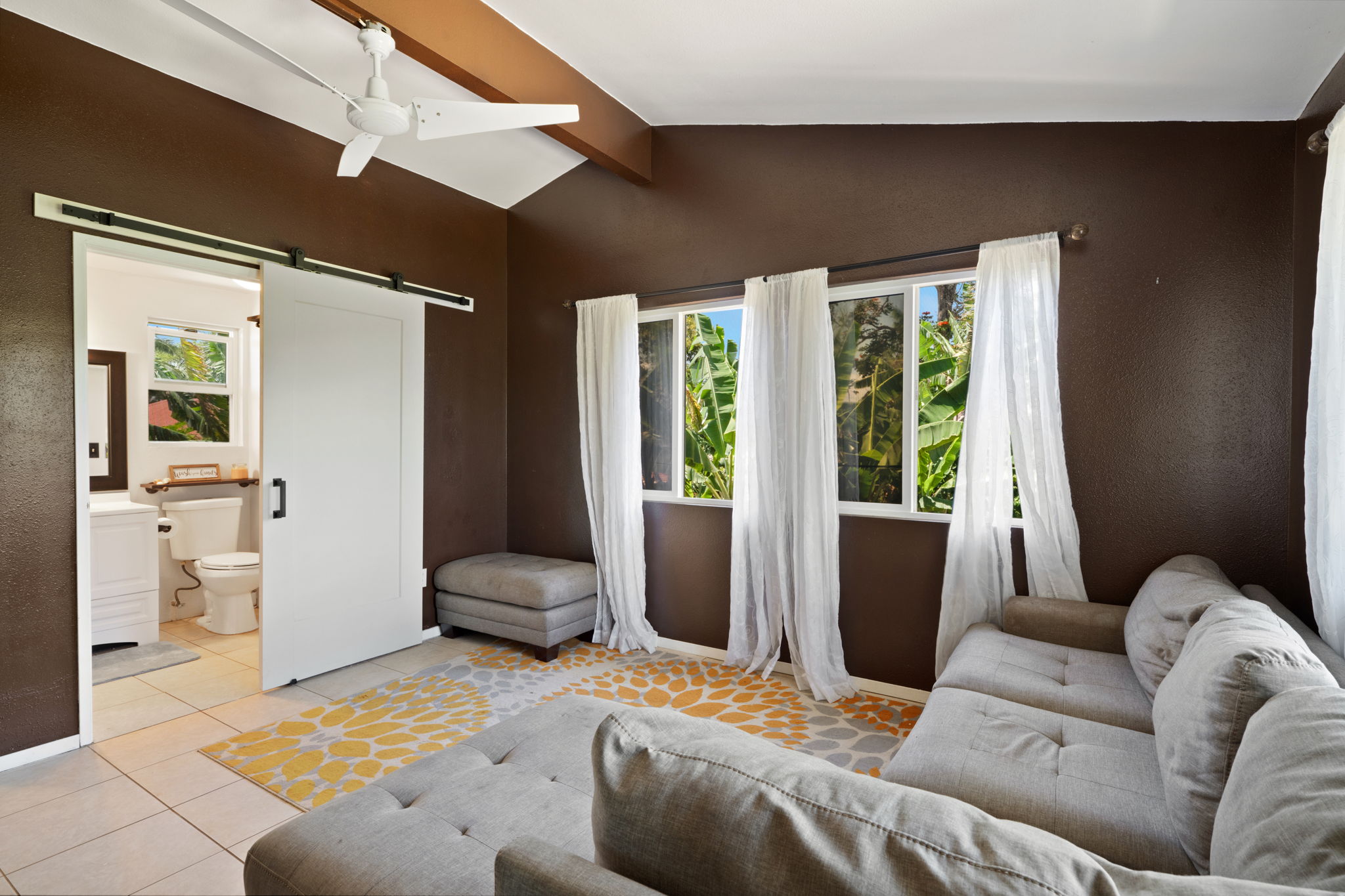 6100 Kawaihau Road Kapaa, HI 96746 - Photo 18 of 22 a bedroom with furniture and a large window