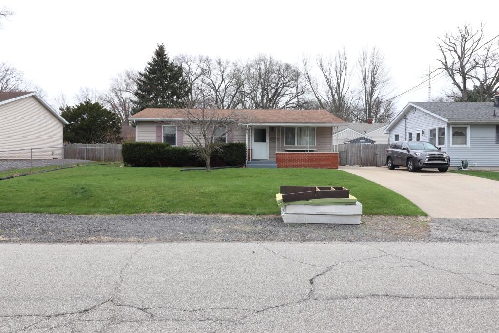 629 Superior Street Michigan City, IN 46360 - Photo 2 of 35 a front view of a house with a garden and trees