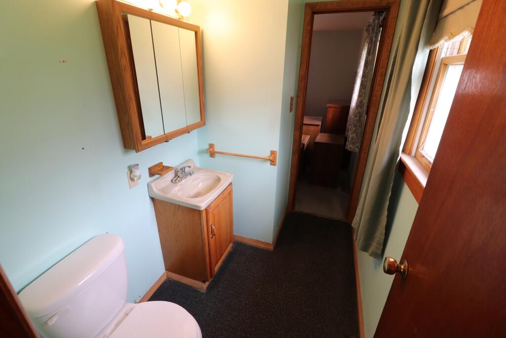 629 Superior Street Michigan City, IN 46360 - Photo 25 of 35 a bathroom with a toilet sink and mirror
