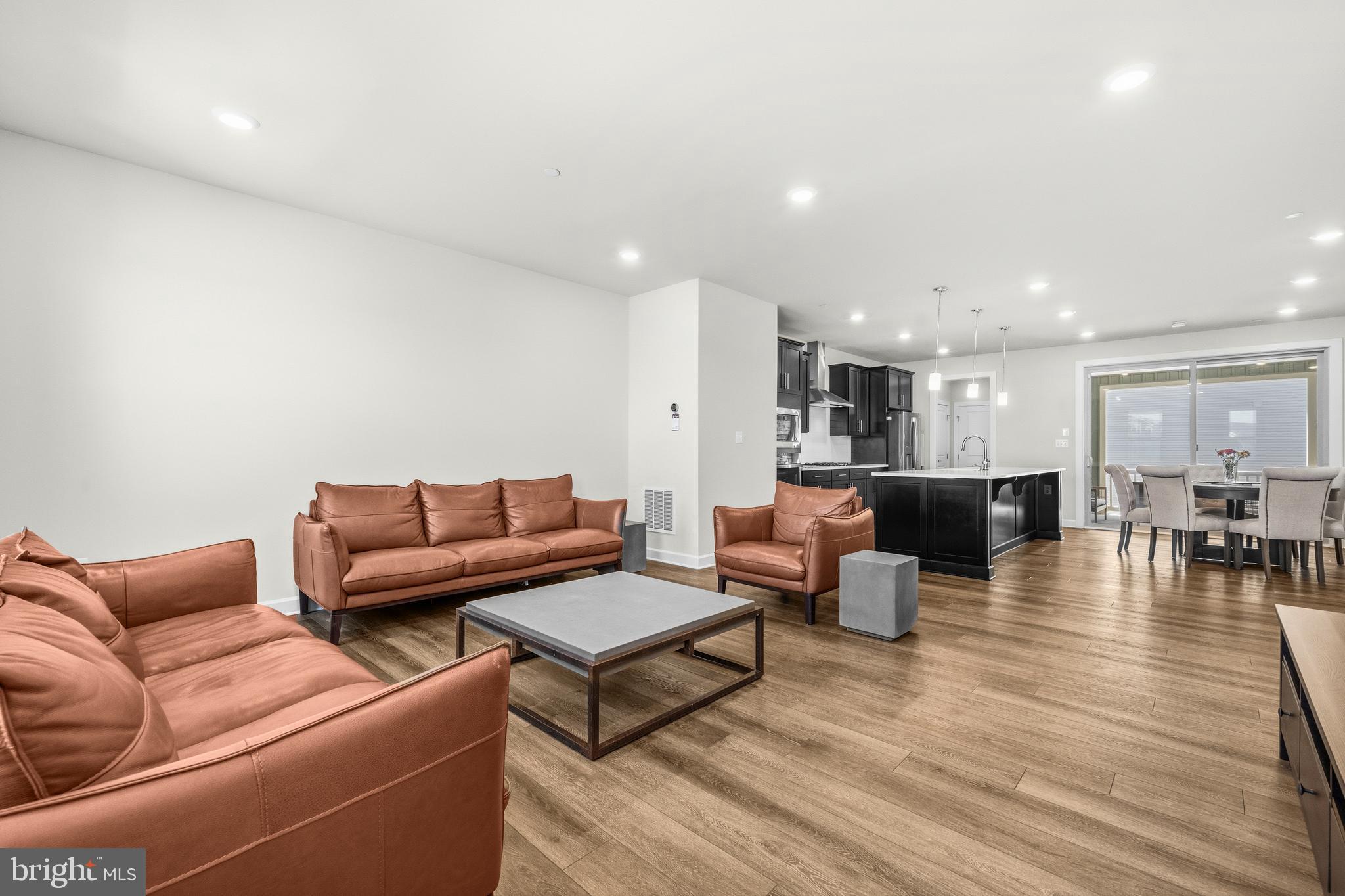 103 Brown Branch Road Laurel, MD 20708 - Photo 13 of 35 a living room with furniture a wooden floor and kitchen view