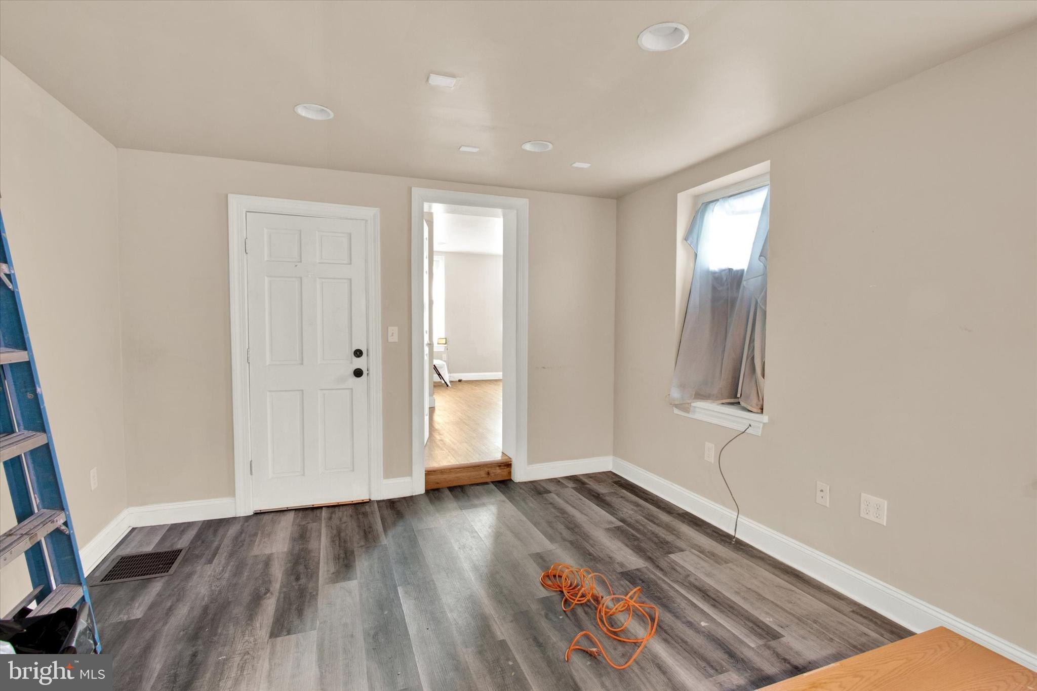 531 Chestnut Street, Unit 2 Reading, PA 19602 - Photo 4 of 8 an empty room with wooden floor and windows
