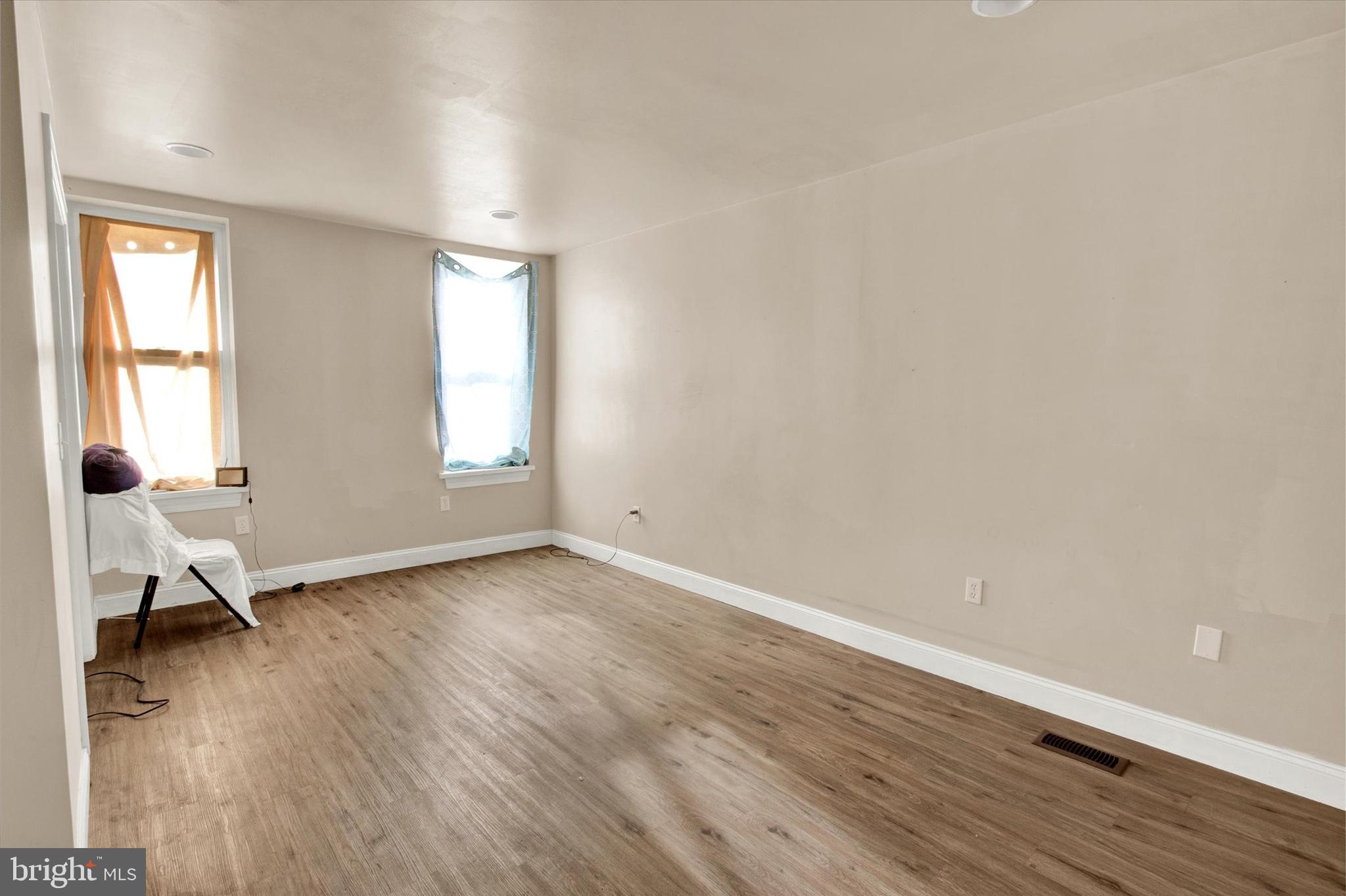 531 Chestnut Street, Unit 2 Reading, PA 19602 - Photo 5 of 8 an empty room with wooden floor and windows