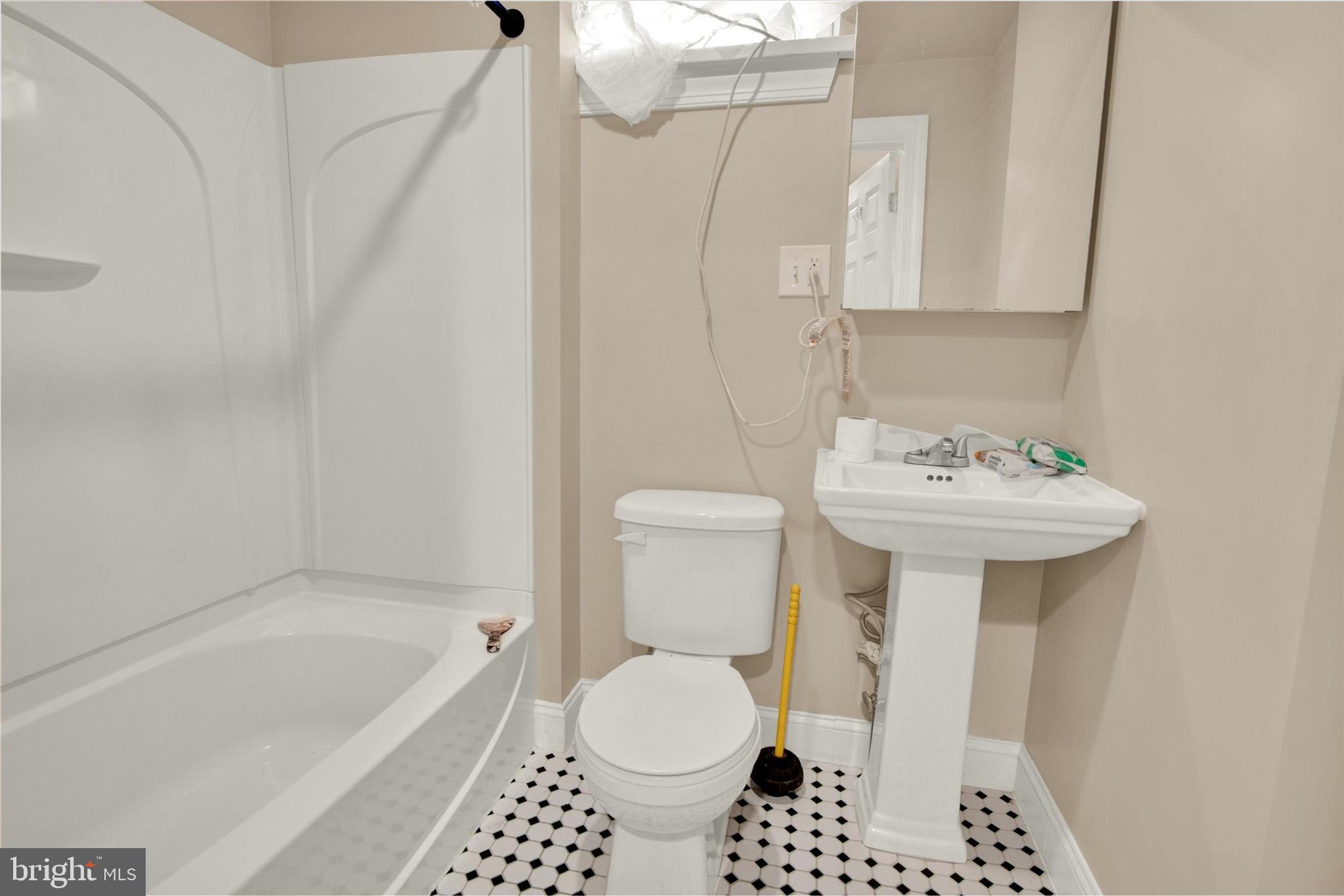 531 Chestnut Street, Unit 2 Reading, PA 19602 - Photo 7 of 8 a bathroom with a sink toilet and shower
