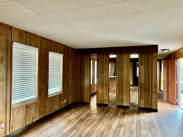 a view of a room with wooden floor and stairs