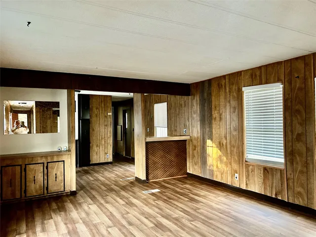 a view of a livingroom with wooden floor and a staircase