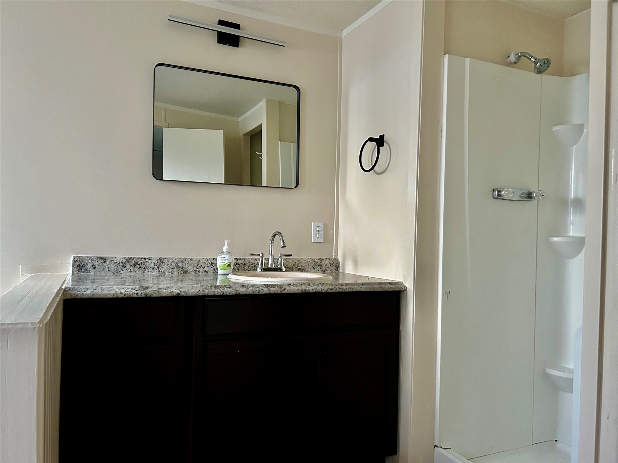 13819 Eagle Pass Street Houston, TX 77015 - Photo 7 of 9 a bathroom with a granite countertop sink a mirror and a