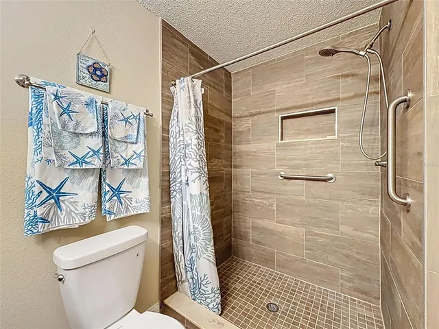 a bathroom with a shower and a toilet