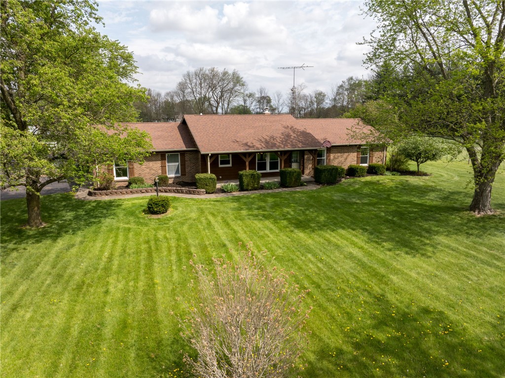 7988 McCool Road Greenville, OH 45331 - Photo 49 of 50 This charming home sits amidst a sprawling, verdant lawn, offering serene curb appeal.