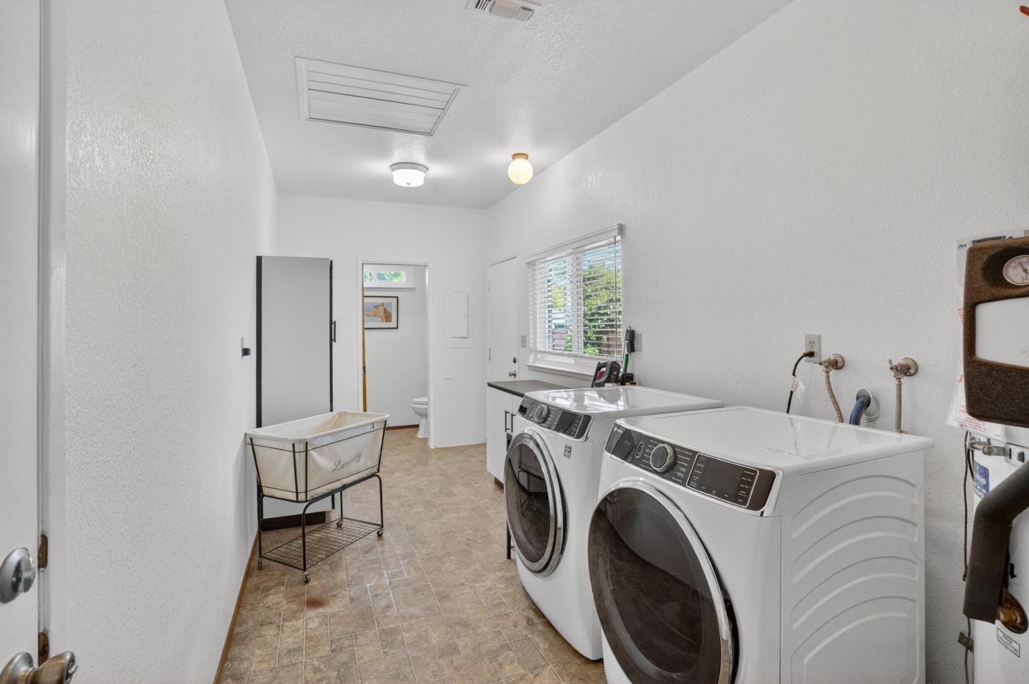 13088 Cherry Road Wilton, CA 95693 - Photo 28 of 58 Laundry room with 1.2 bath and exit to backyard.