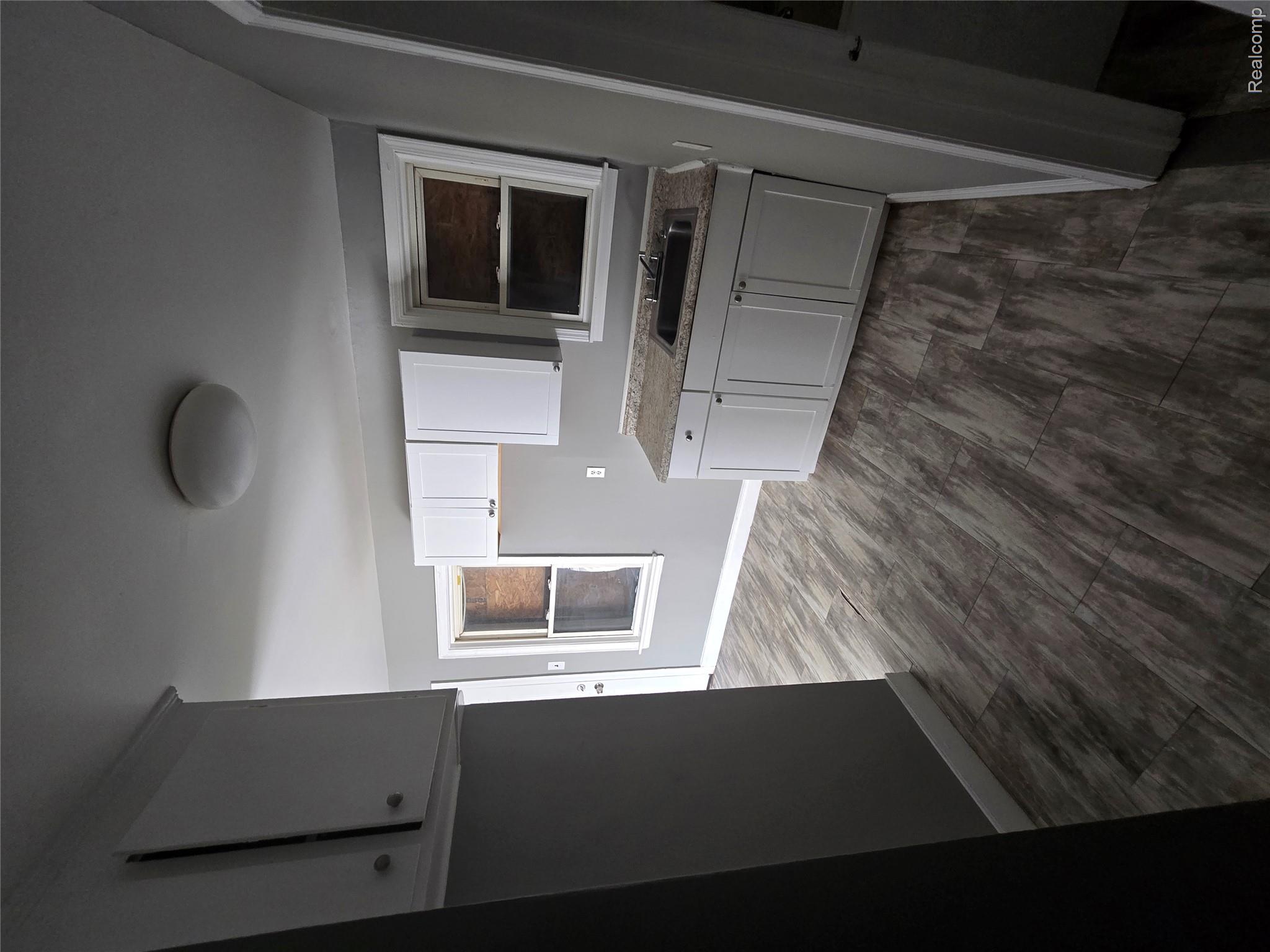 18119 Cornwall Street Detroit, MI 48224 - Photo 7 of 18 Kitchen featuring white cabinets and light countertops