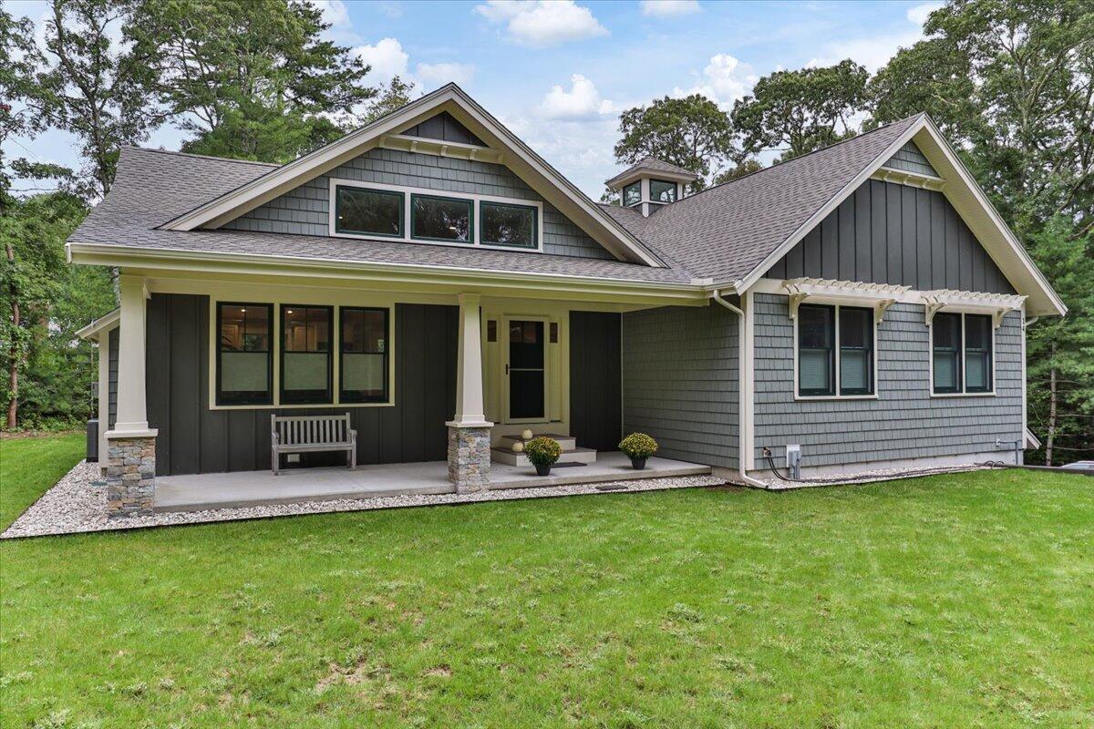 14 Valley Brook Road Centerville, MA 02632 - Photo 2 of 47 a front view of a house with a yard and porch