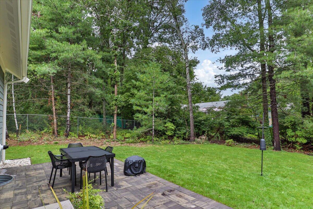 14 Valley Brook Road Centerville, MA 02632 - Photo 42 of 47 a view of a table and chairs in backyard of a house