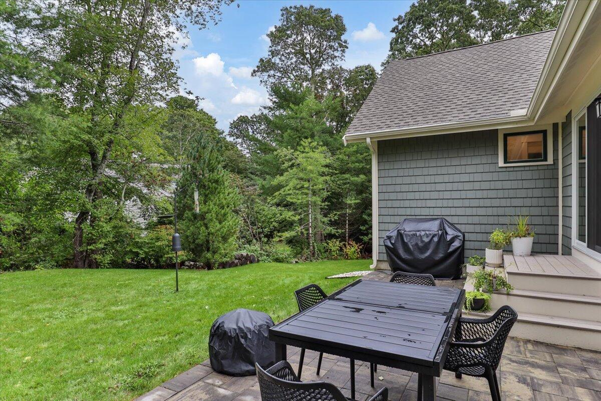 14 Valley Brook Road Centerville, MA 02632 - Photo 43 of 47 a view of a table and chairs in backyard of the house