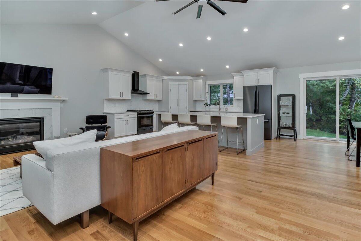 14 Valley Brook Road Centerville, MA 02632 - Photo 6 of 47 a large kitchen with stainless steel appliances granite countertop a stove top oven a refrigerator a sink and a dining table with wooden floor