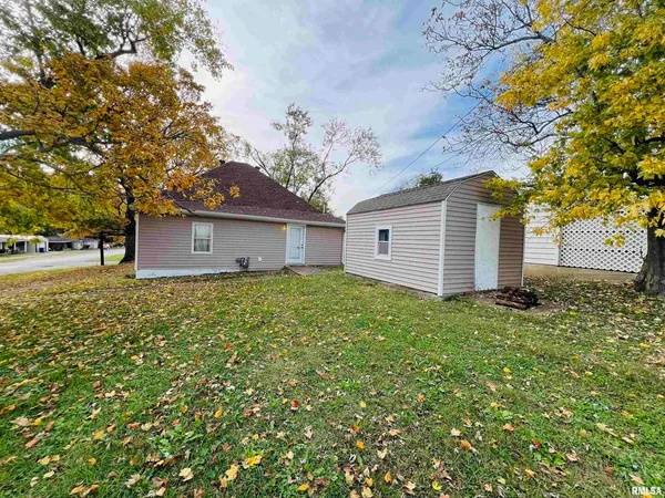 a large kitchen with granite countertop a stove top oven a sink dishwasher a dining table and chairs with wooden floor