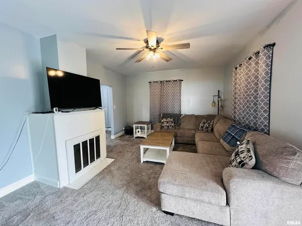 a living room with furniture and a dining table