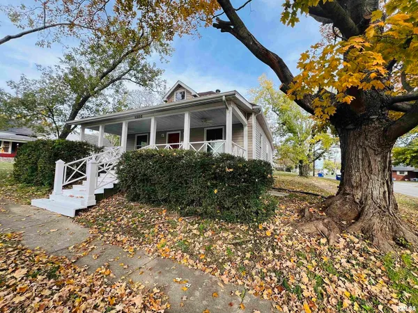a view of a house with a tree in the background