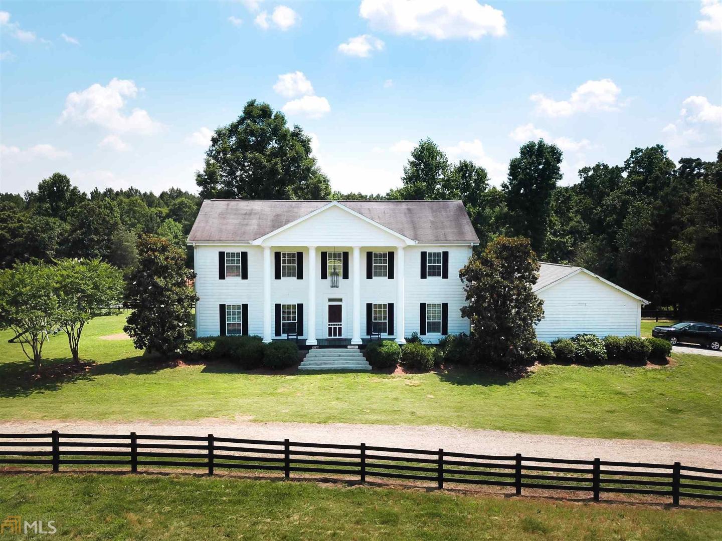 727 Sarijon Road Hartwell, GA 30643 - Photo 1 of 1 a view of a white house with a big yard and potted plants