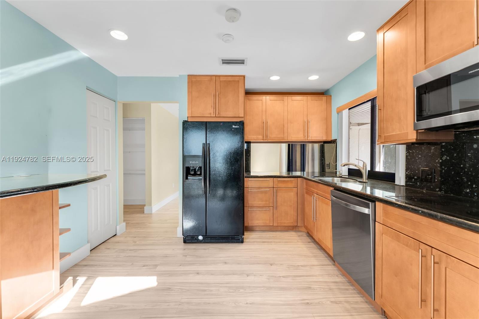 11525 Southwest 135th Court Miami, FL 33186 - Photo 11 of 42 a kitchen with stainless steel appliances granite countertop a refrigerator a sink and a stove