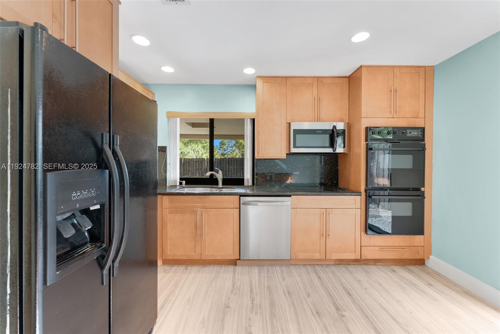 11525 Southwest 135th Court Miami, FL 33186 - Photo 12 of 42 a kitchen with stainless steel appliances a refrigerator and a stove top oven