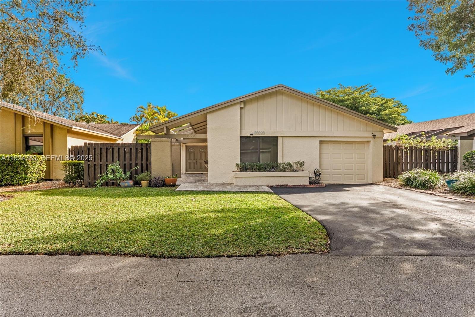 11525 Southwest 135th Court Miami, FL 33186 - Photo 2 of 42 a front view of a house with a garden and porch
