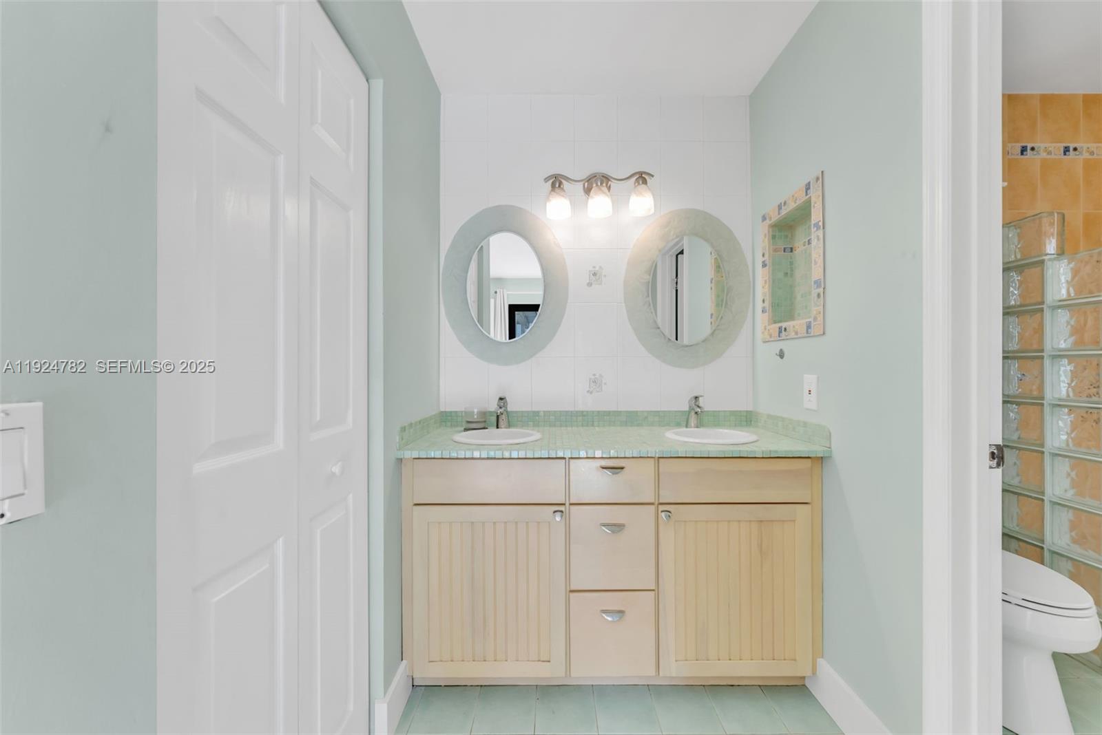 11525 Southwest 135th Court Miami, FL 33186 - Photo 22 of 42 a spacious bathroom with a double vanity sink and a mirror