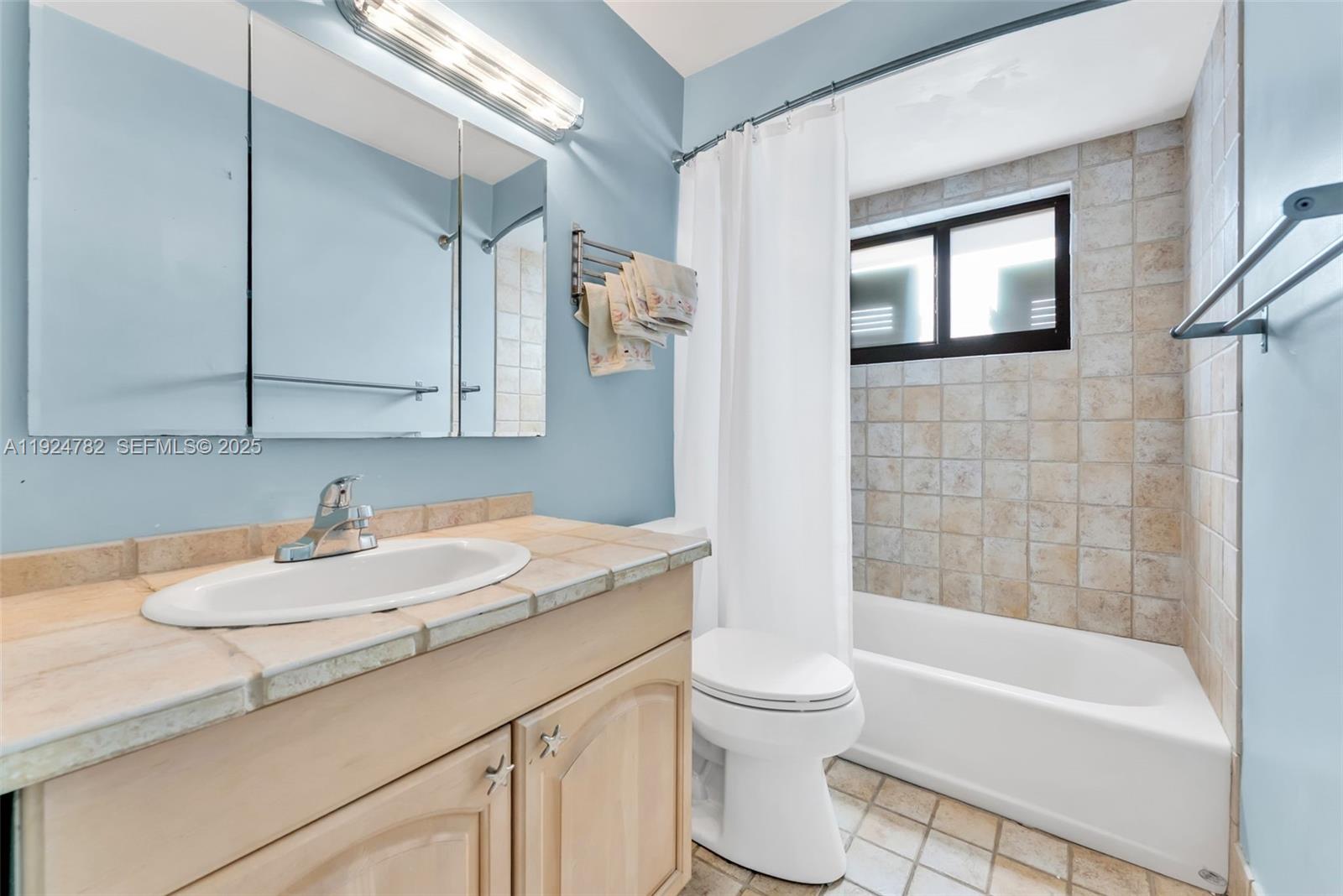 11525 Southwest 135th Court Miami, FL 33186 - Photo 24 of 42 a bathroom with a granite countertop sink toilet and shower