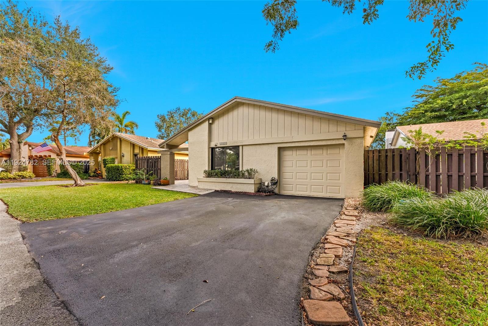 11525 Southwest 135th Court Miami, FL 33186 - Photo 3 of 42 a view of a house with a yard and garage