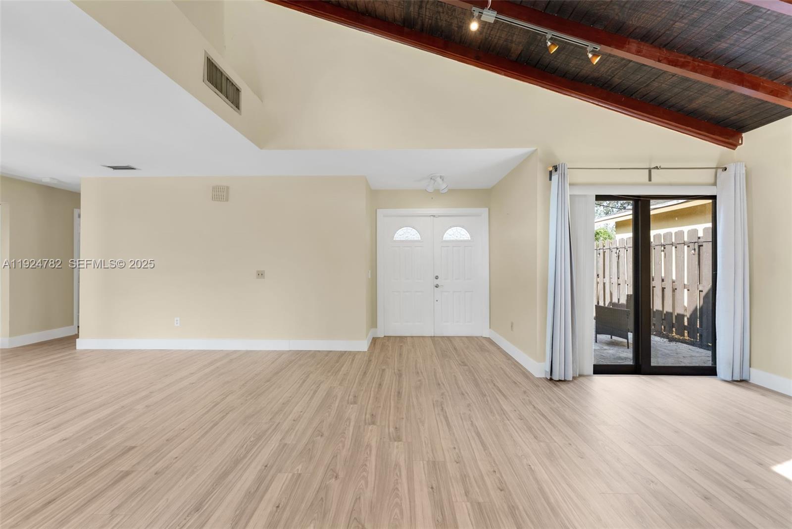11525 Southwest 135th Court Miami, FL 33186 - Photo 4 of 42 wooden floor in an empty room with a window