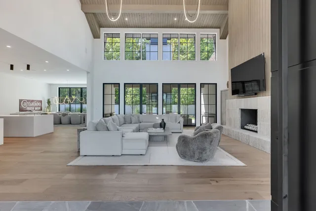 a spacious bedroom with a bed and a large window