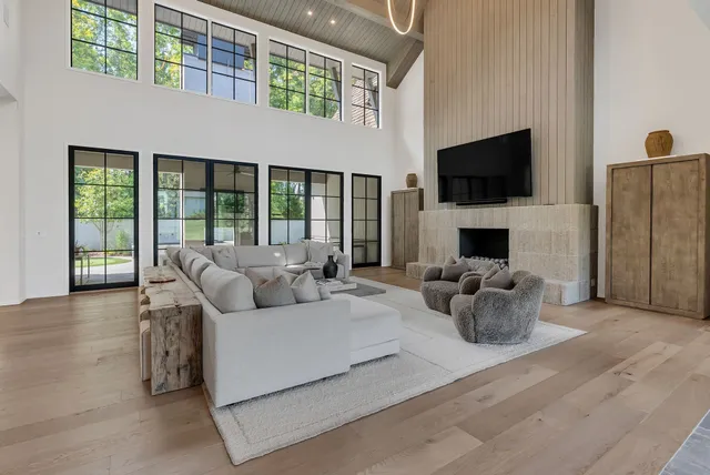 a spacious bedroom with a bed and a chandelier
