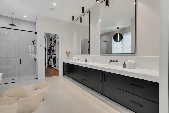 a bathroom with a granite countertop sink toilet and mirror