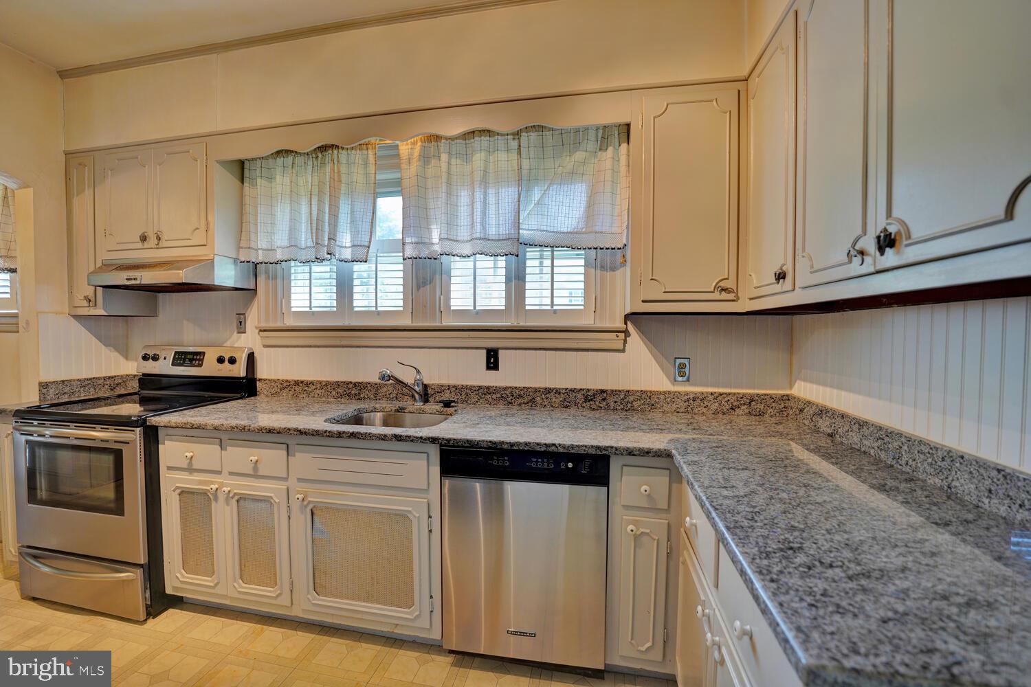 21 Hazel Road Dover, DE 19901 - Photo 27 of 69 a kitchen with stainless steel appliances granite countertop a sink and cabinets with wooden floor