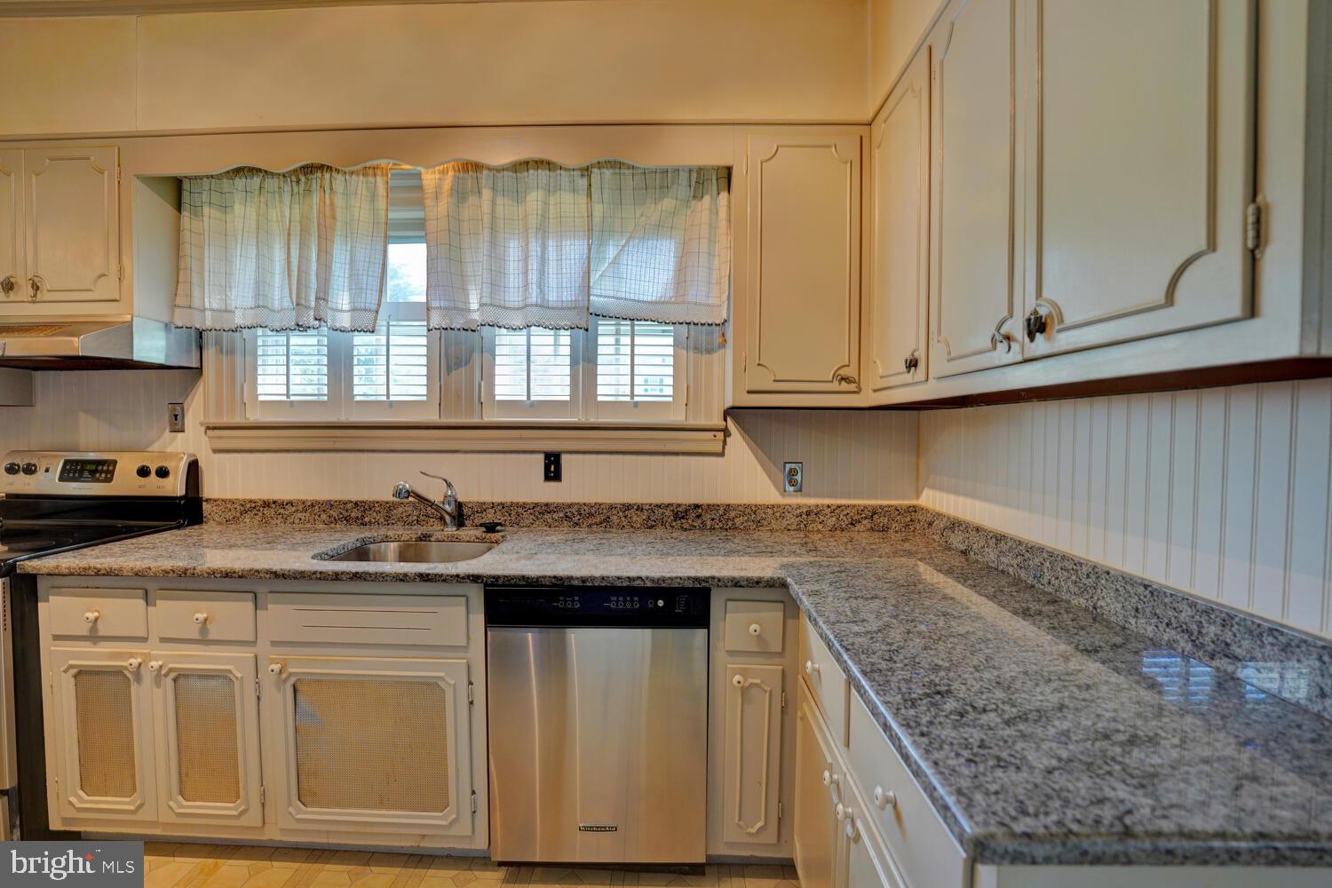 21 Hazel Road Dover, DE 19901 - Photo 28 of 69 a kitchen with granite countertop a sink and a white wooden cabinets