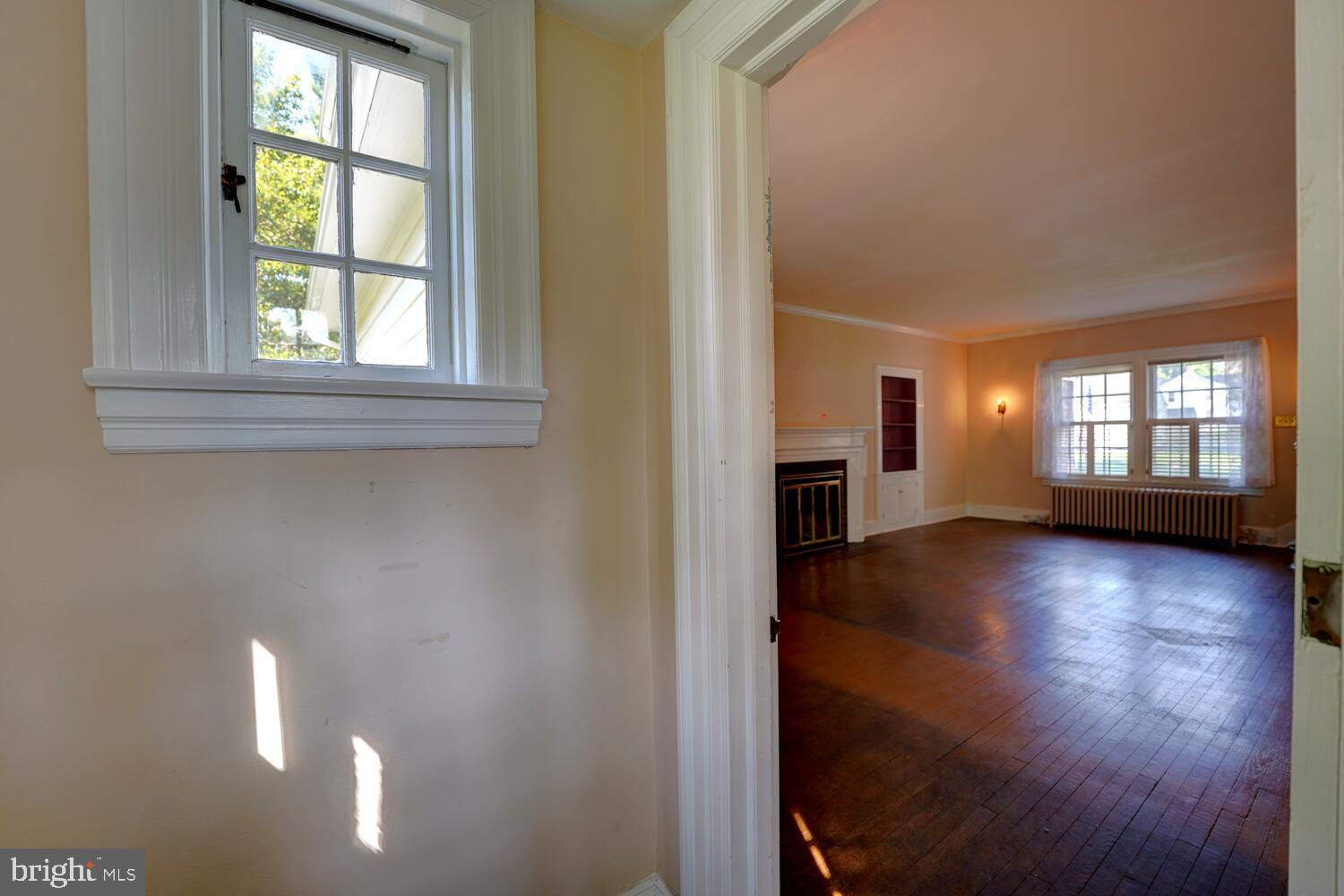 21 Hazel Road Dover, DE 19901 - Photo 7 of 69 a view of an empty room with a window and wooden floor