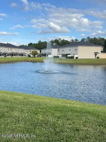 a view of a lake with houses in the back