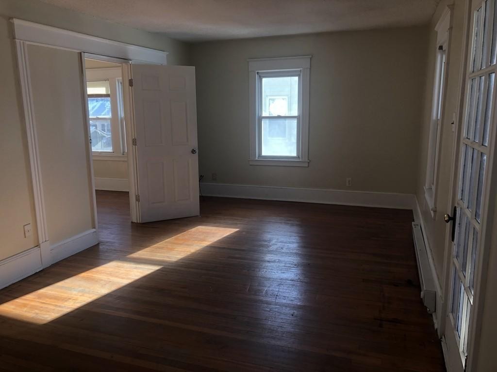 43-45 Jenness Street Springfield, MA 01104 - Photo 9 of 21 an empty room with wooden floor and windows