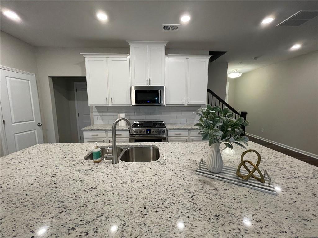 500 Duval Drive Alpharetta, GA 30009 - Photo 5 of 21 a kitchen with a sink stainless steel appliances and cabinets