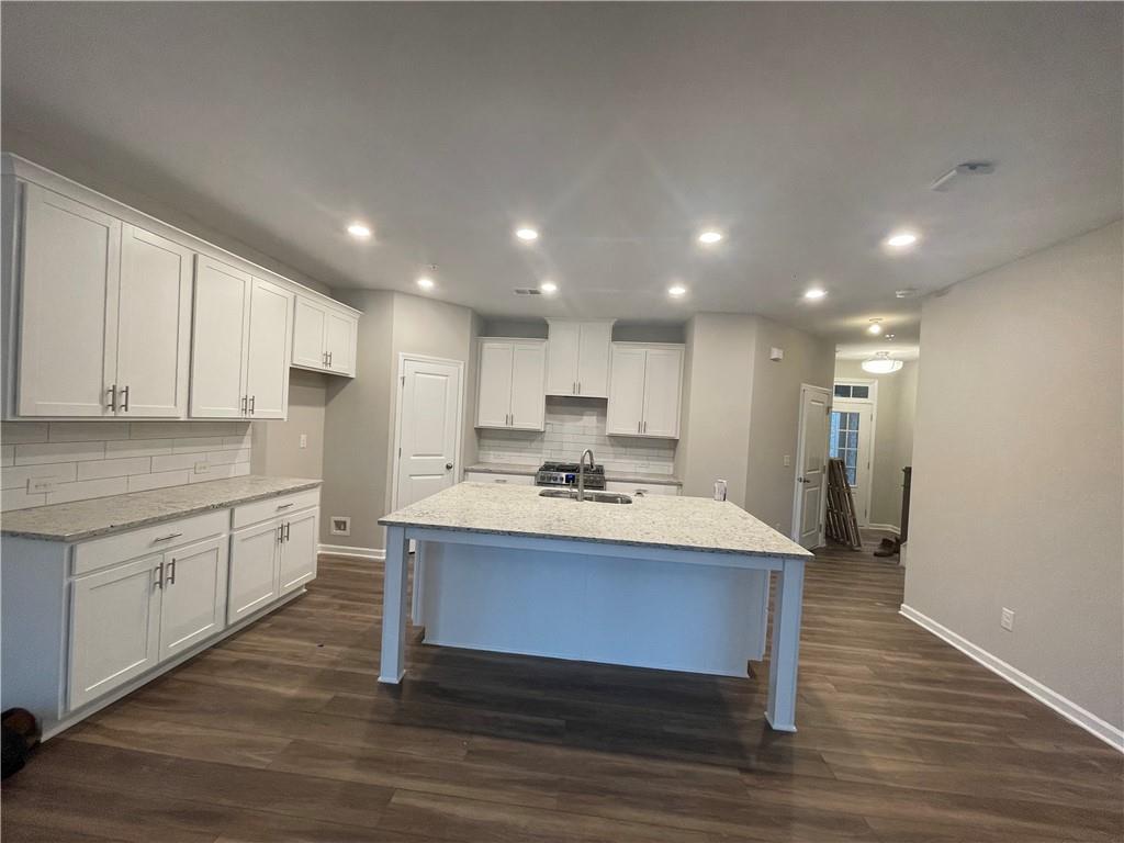 500 Duval Drive Alpharetta, GA 30009 - Photo 7 of 21 a kitchen with kitchen island a sink and a stove