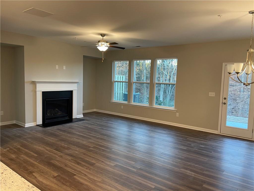 500 Duval Drive Alpharetta, GA 30009 - Photo 8 of 21 an empty room with wooden floor fireplace and windows