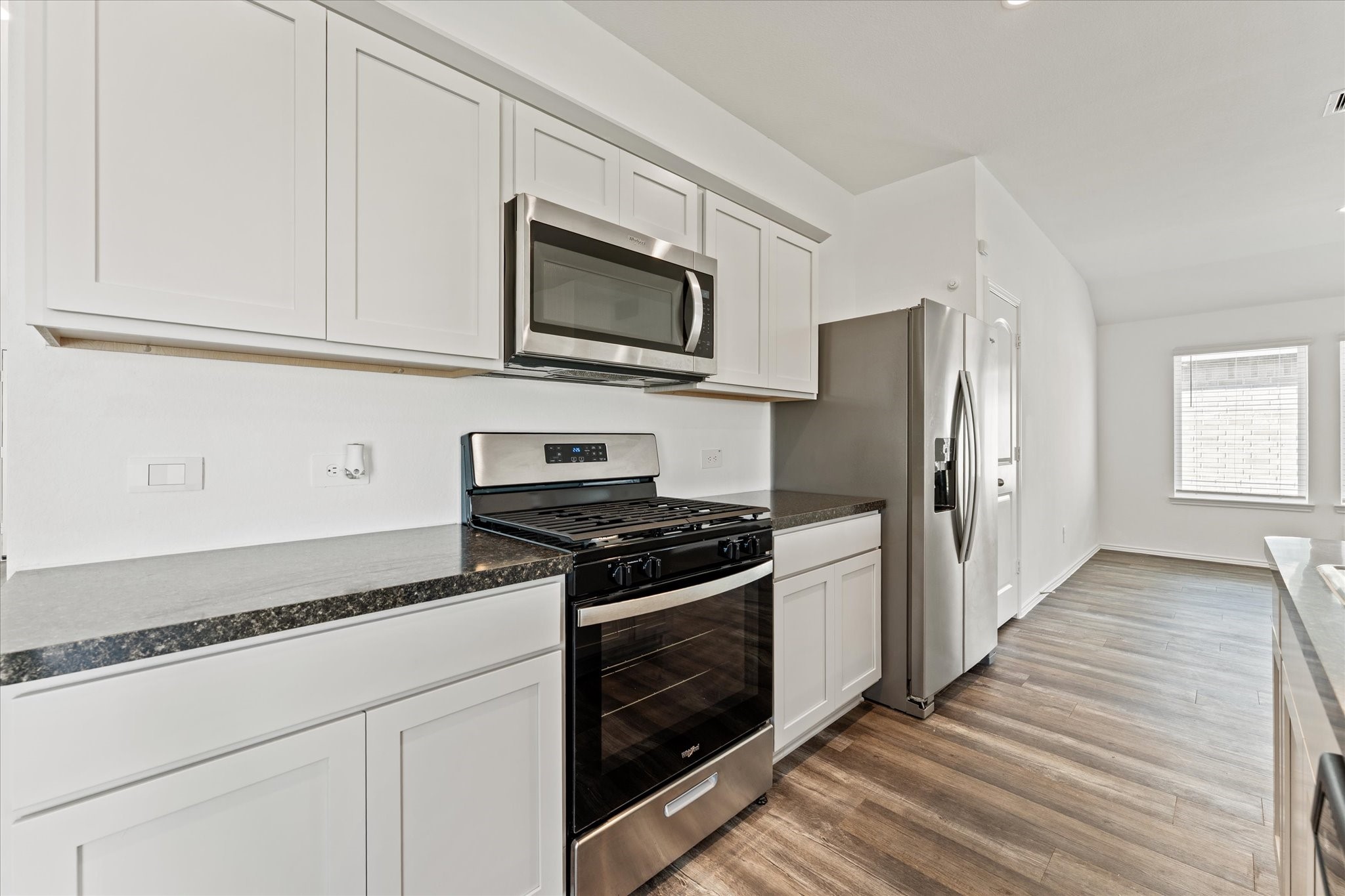 24210 Sandstone Valley Lane Spring, TX 77373 - Photo 12 of 33 a kitchen with stainless steel appliances a stove microwave and refrigerator