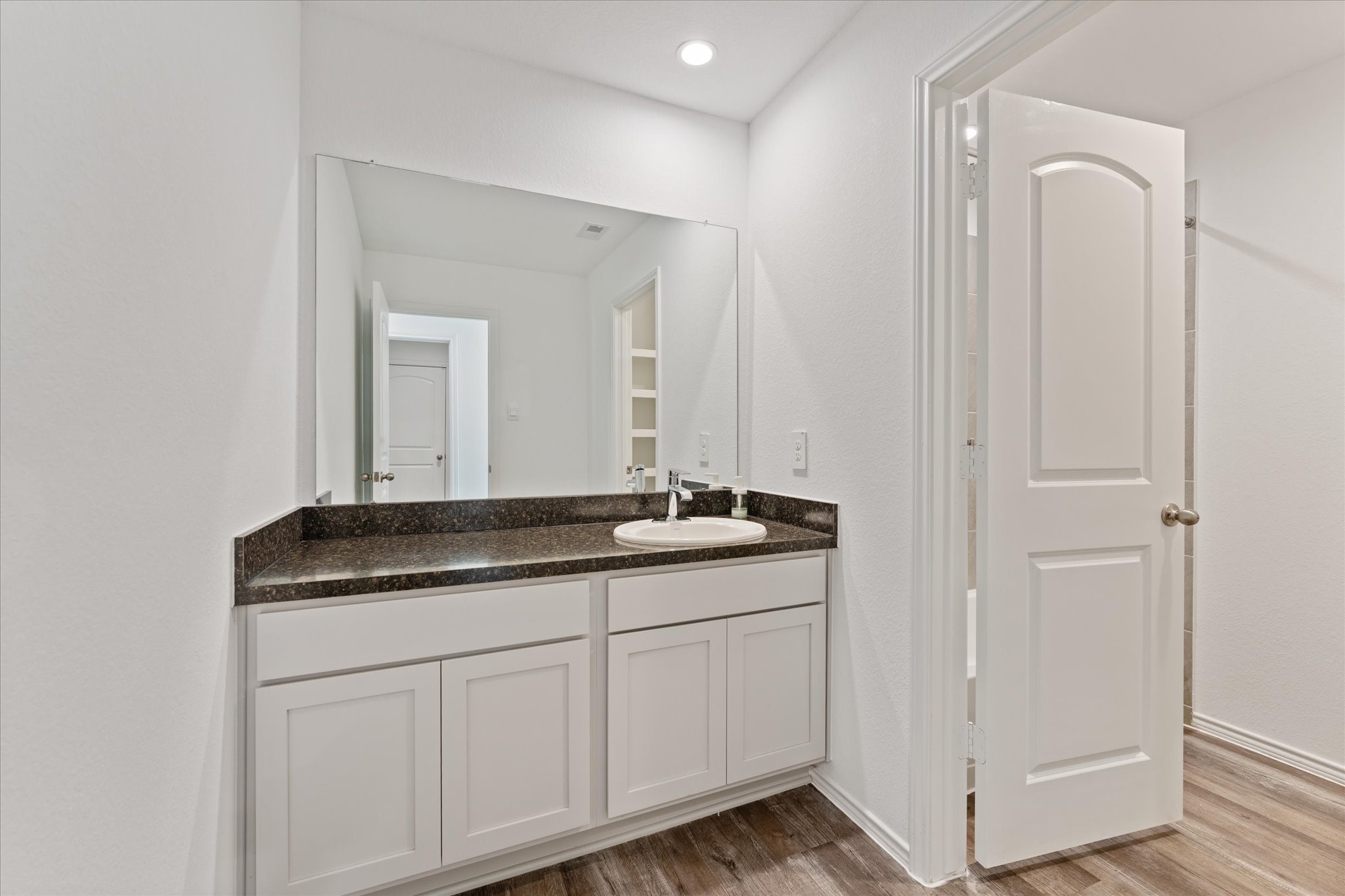 24210 Sandstone Valley Lane Spring, TX 77373 - Photo 23 of 33 a bathroom with a granite countertop sink and a mirror