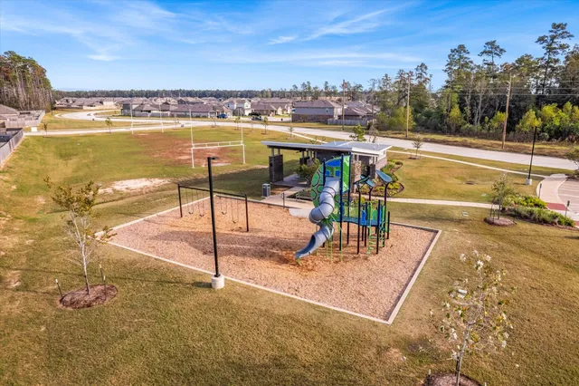 a view of a house with a yard and pathway