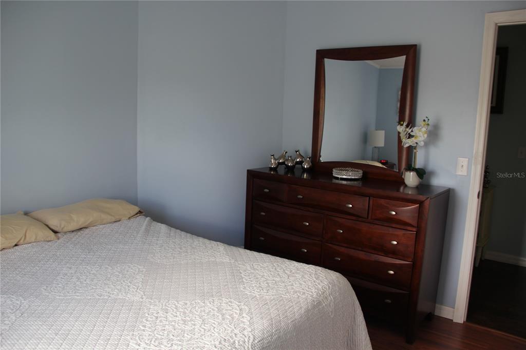 13127 Star Road Brooksville, FL 34613 - Photo 23 of 54 a bedroom with a bed and a mirror on dresser